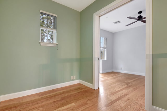 spare room with ceiling fan and light wood-type flooring