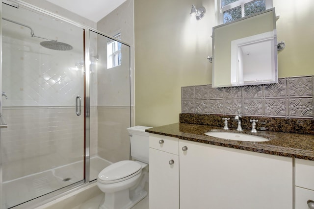 bathroom featuring vanity, an enclosed shower, and tasteful backsplash