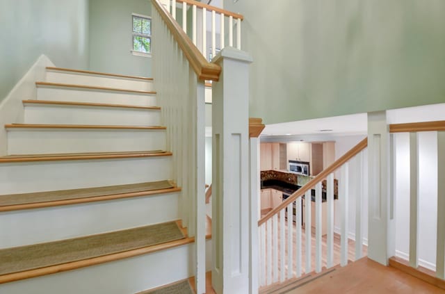 staircase featuring a towering ceiling