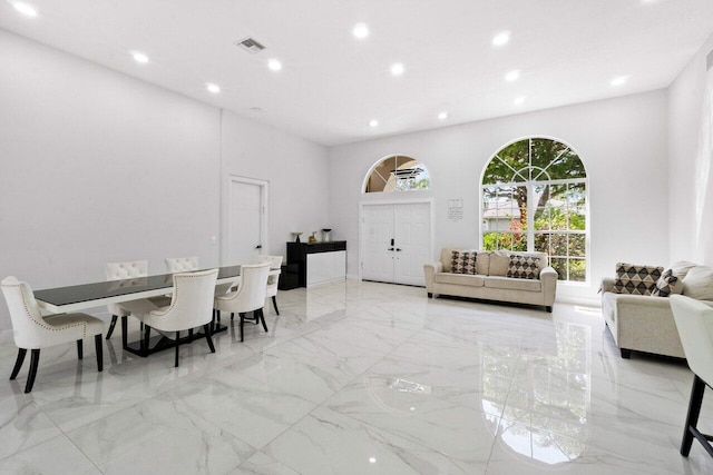 dining room featuring a towering ceiling