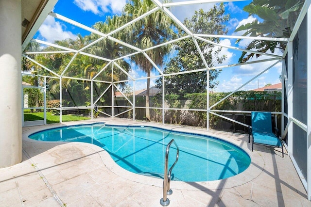 view of swimming pool with a patio and glass enclosure