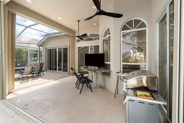 sunroom / solarium featuring ceiling fan