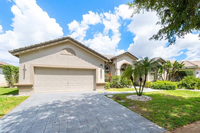 view of front facade featuring a front yard and a garage