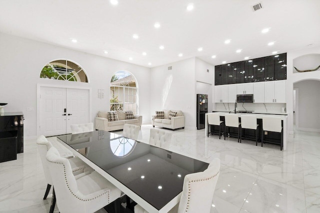 interior space with a towering ceiling and sink