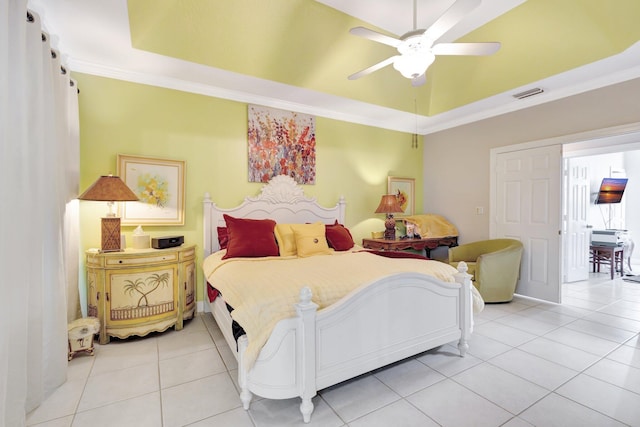 bedroom featuring light tile patterned flooring, visible vents, crown molding, and a tray ceiling