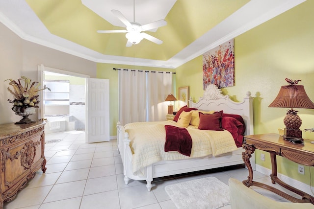 bedroom featuring light tile patterned floors, a tray ceiling, and crown molding