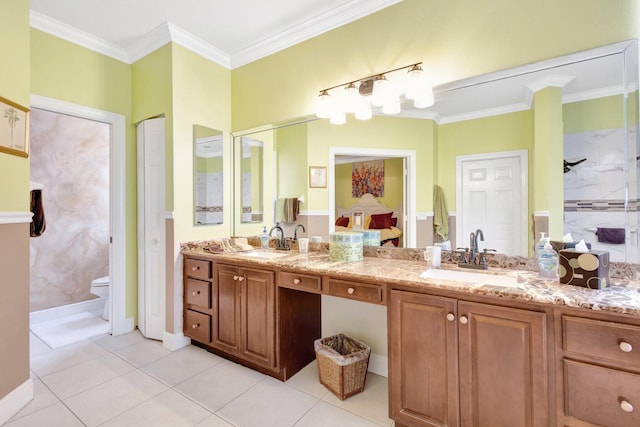 bathroom with a sink, toilet, ornamental molding, and double vanity