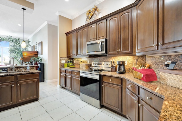 kitchen featuring light stone counters, a sink, ornamental molding, stainless steel appliances, and backsplash