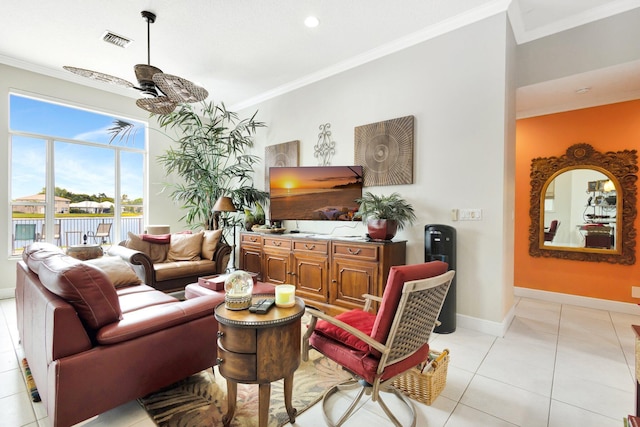 living room with visible vents, ceiling fan, baseboards, ornamental molding, and light tile patterned floors