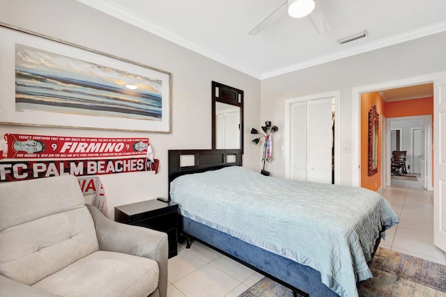 bedroom featuring a closet, ceiling fan, crown molding, and tile patterned flooring