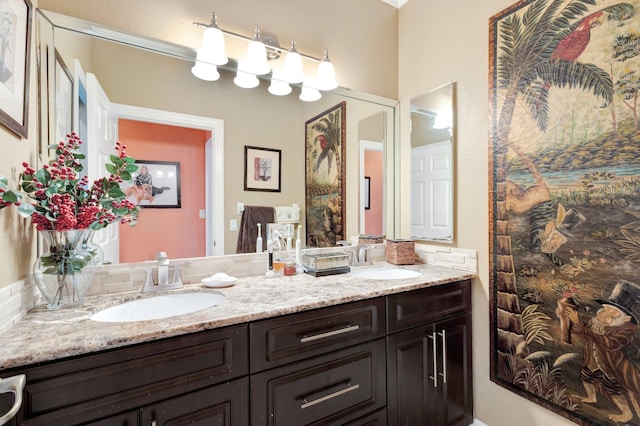 full bathroom with a sink and double vanity