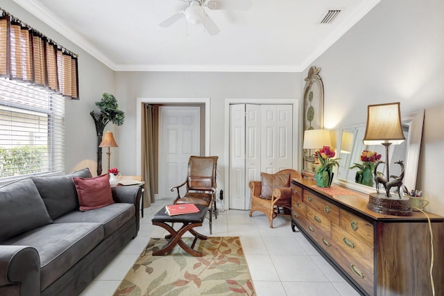 living room with light tile patterned floors, visible vents, crown molding, and ceiling fan