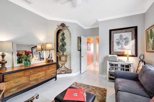 living room featuring light tile patterned floors, a ceiling fan, baseboards, visible vents, and crown molding