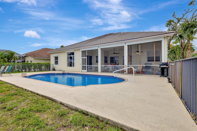 view of pool with a patio, fence, a ceiling fan, and a sunroom