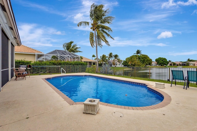 view of pool with a fenced backyard, a fenced in pool, glass enclosure, and a patio