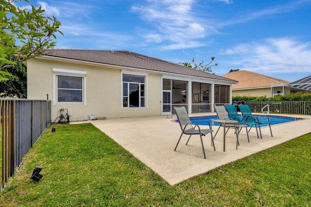 rear view of property with a patio, a lawn, a fenced backyard, and a sunroom