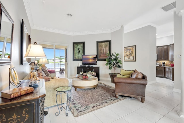 living room with light tile patterned floors, visible vents, and crown molding