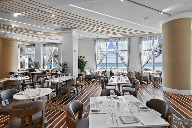 dining area with a water view and floor to ceiling windows