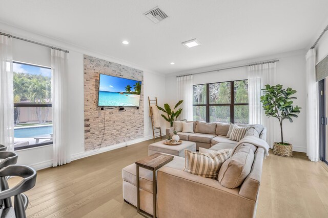 interior space with crown molding, recessed lighting, built in study area, and light wood-style floors