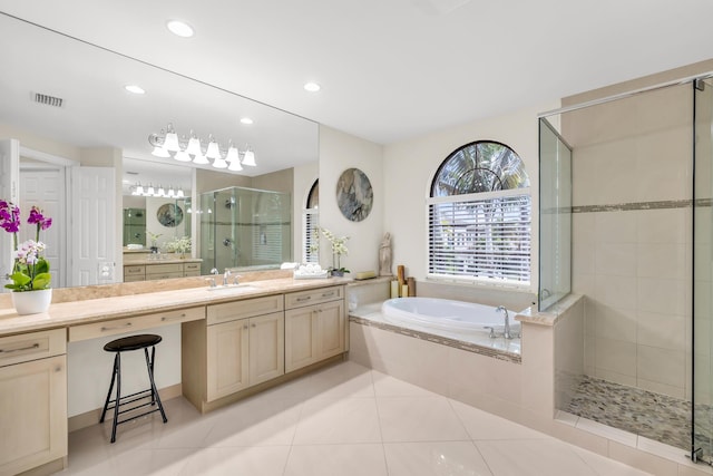 bathroom with vanity, independent shower and bath, and tile patterned flooring