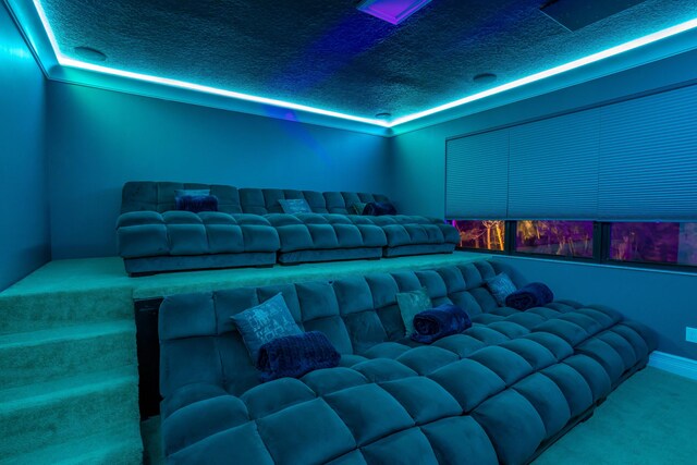 carpeted home theater featuring a textured ceiling