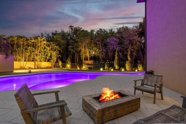 back of house featuring a patio area, an outdoor pool, a tiled roof, and stucco siding