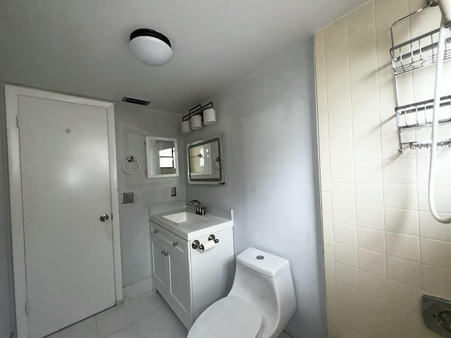 bathroom with tile patterned flooring, vanity, toilet, and a shower