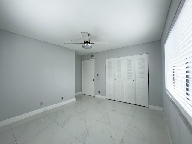 unfurnished bedroom with a closet and ceiling fan