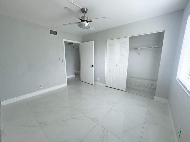 unfurnished bedroom featuring ceiling fan and a closet