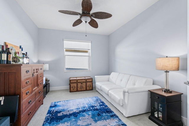 interior space with ceiling fan and light colored carpet