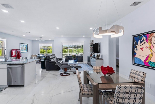 dining space with sink and ceiling fan