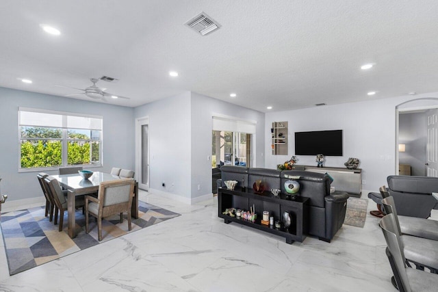 dining area featuring a textured ceiling and ceiling fan