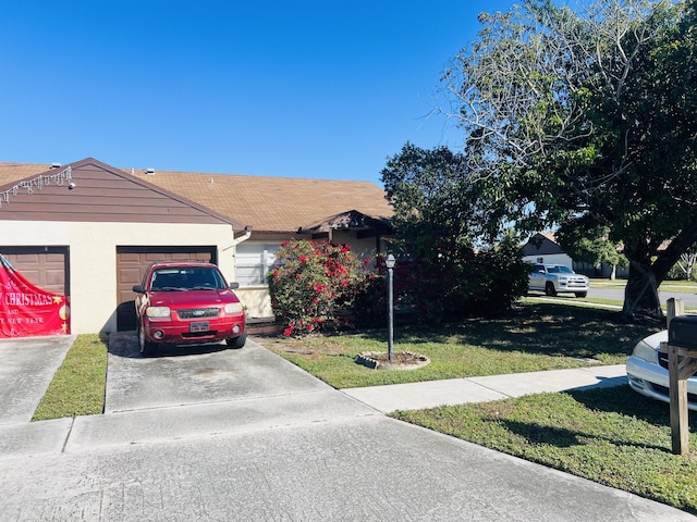 view of front facade featuring a garage and a front lawn