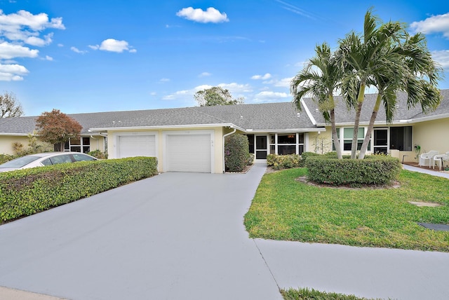 single story home featuring a front lawn and a garage