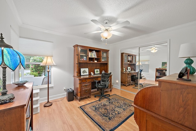 home office featuring ornamental molding, light hardwood / wood-style floors, and a textured ceiling