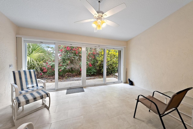 sitting room featuring ceiling fan, a wealth of natural light, and a textured ceiling