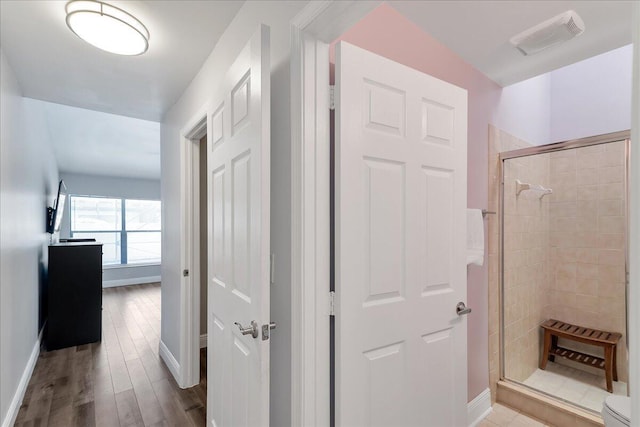 corridor with light hardwood / wood-style floors