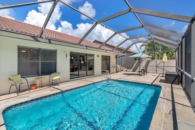 view of pool with a lanai and a patio