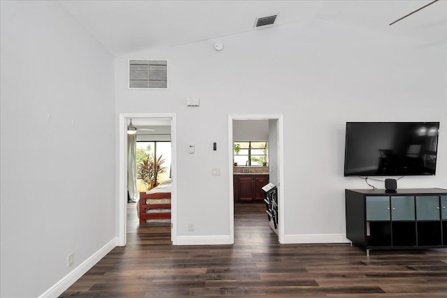 living room with dark hardwood / wood-style flooring, high vaulted ceiling, and ceiling fan