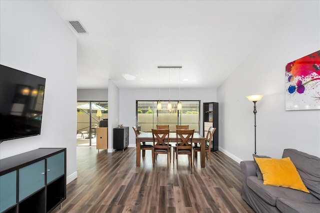 dining area with dark hardwood / wood-style flooring