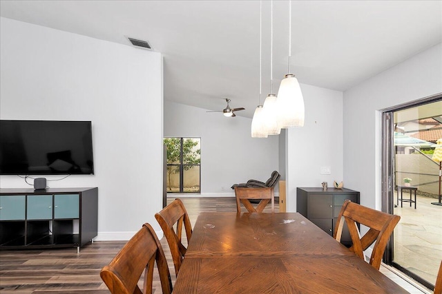 dining space with lofted ceiling, ceiling fan, and dark wood-type flooring