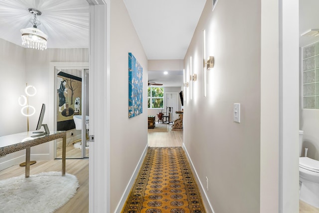 hall featuring an inviting chandelier