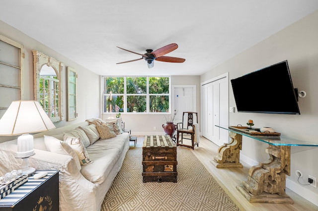 living room featuring ceiling fan and light wood-type flooring