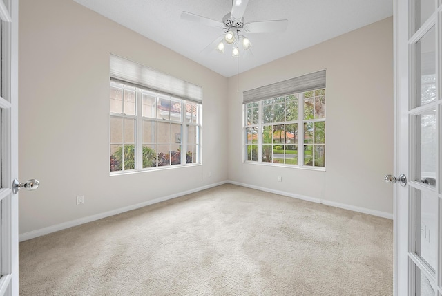 spare room featuring ceiling fan and carpet