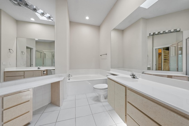 full bathroom with tile patterned flooring, vanity, a skylight, shower with separate bathtub, and toilet