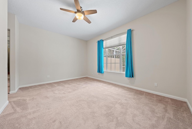 carpeted empty room featuring a textured ceiling and ceiling fan