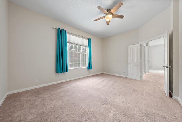 carpeted empty room featuring ceiling fan and a textured ceiling