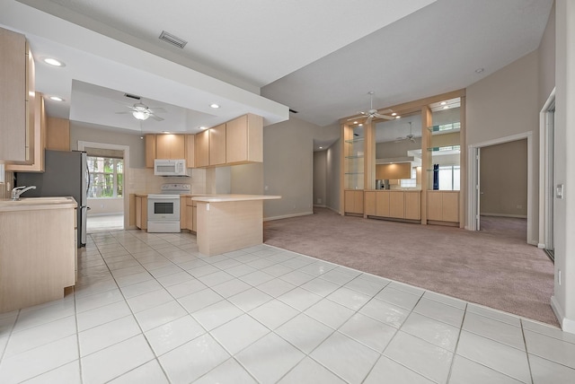 kitchen with ceiling fan, light colored carpet, light brown cabinets, and white appliances