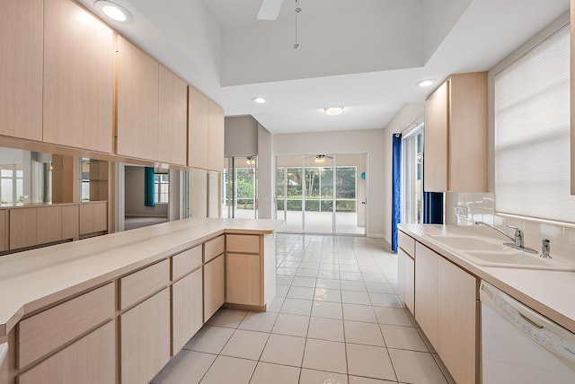 kitchen featuring light tile patterned floors, dishwasher, sink, and light brown cabinets