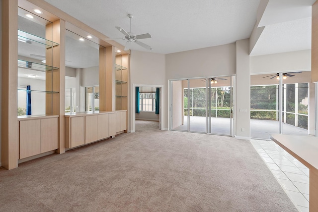 unfurnished living room featuring light carpet